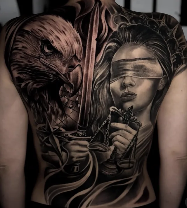 Full back black and grey realism tattoo of a blindfolded Lady Justice with scales and sword beside a bald eagle