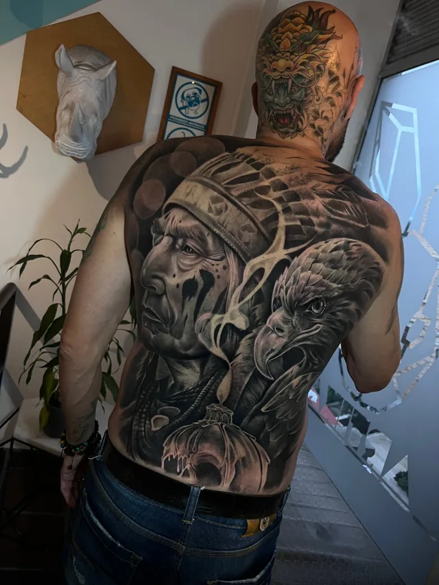 Full back black and grey realism tattoo of a Native chief portrait with an eagle